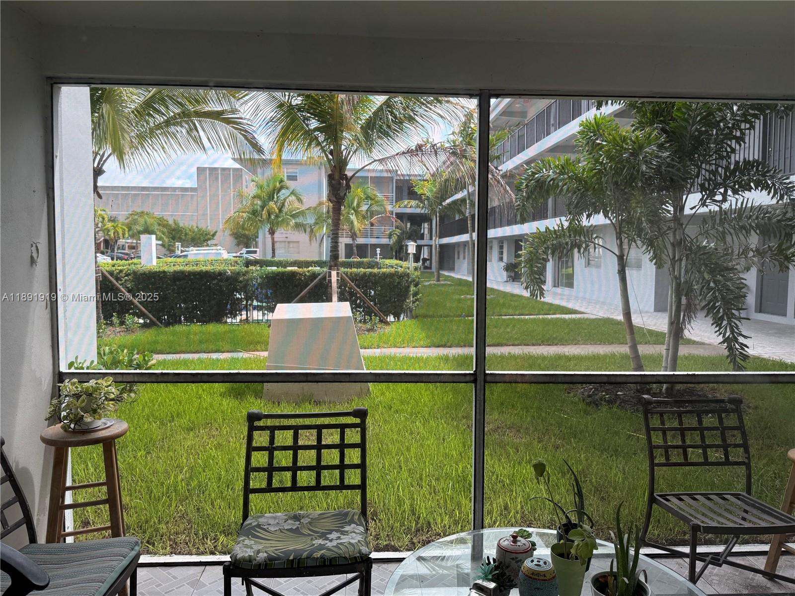 1100 Northeast 1st Court, Unit 120 Hallandale Beach, FL 33009 - Photo 2 of 45 a view of a chairs and table in the balcony