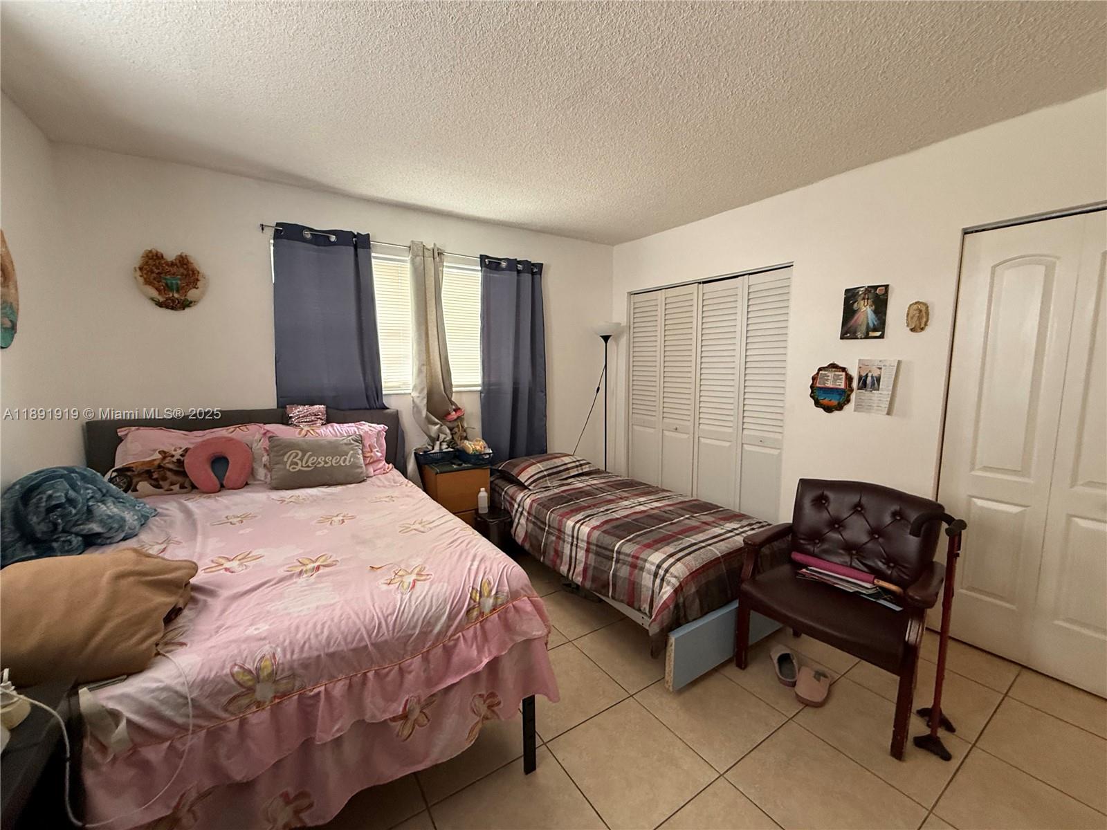 1100 Northeast 1st Court, Unit 120 Hallandale Beach, FL 33009 - Photo 21 of 45 a bedroom with a bed and a window