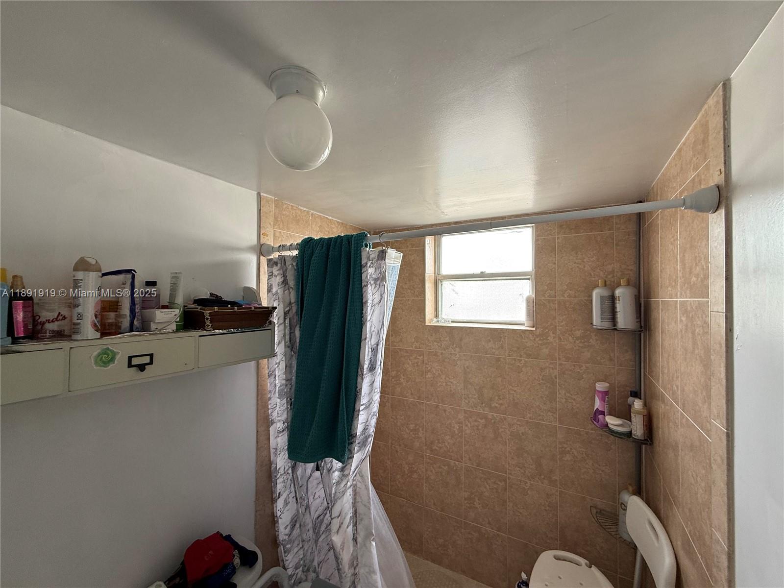 1100 Northeast 1st Court, Unit 120 Hallandale Beach, FL 33009 - Photo 22 of 45 a bathroom with a shower and a tub