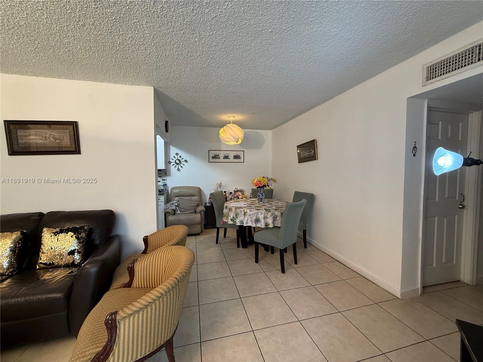 1100 Northeast 1st Court, Unit 120 Hallandale Beach, FL 33009 - Photo 36 of 45 a living room with furniture and a fireplace