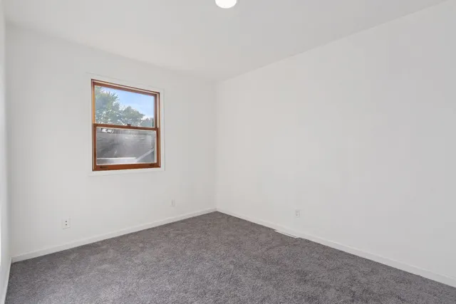 a room with a white wall and a window