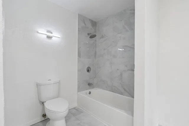 a bathroom with a bathtub and toilet