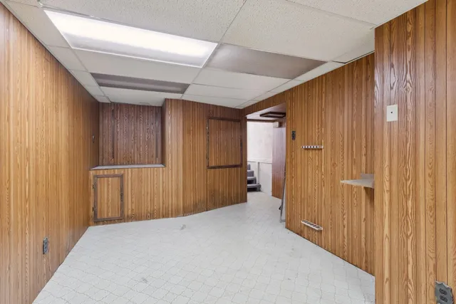 a view of hallway with wooden walls