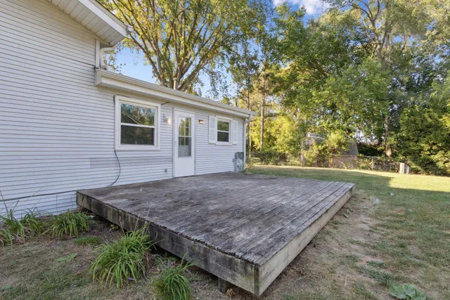 a view of a backyard with a wooden fence
