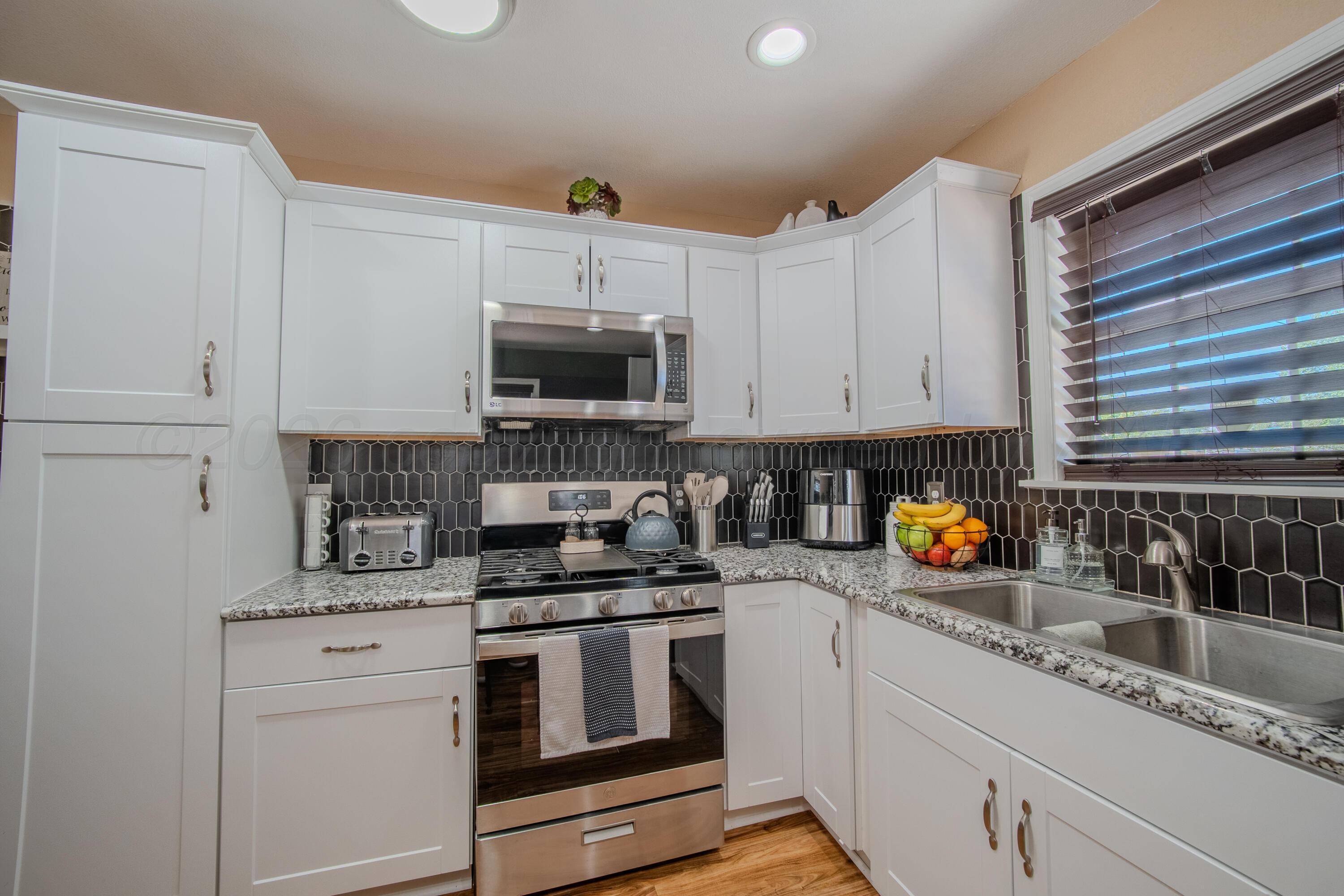 4014 Gables Street Amarillo, TX 79110 - Photo 5 of 14 a kitchen with appliances a sink and cabinets