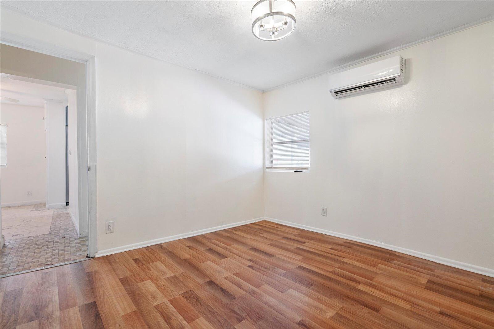 236 Southwest 14th Street Dania Beach, FL 33004 - Photo 12 of 19 an empty room with wooden floor and windows