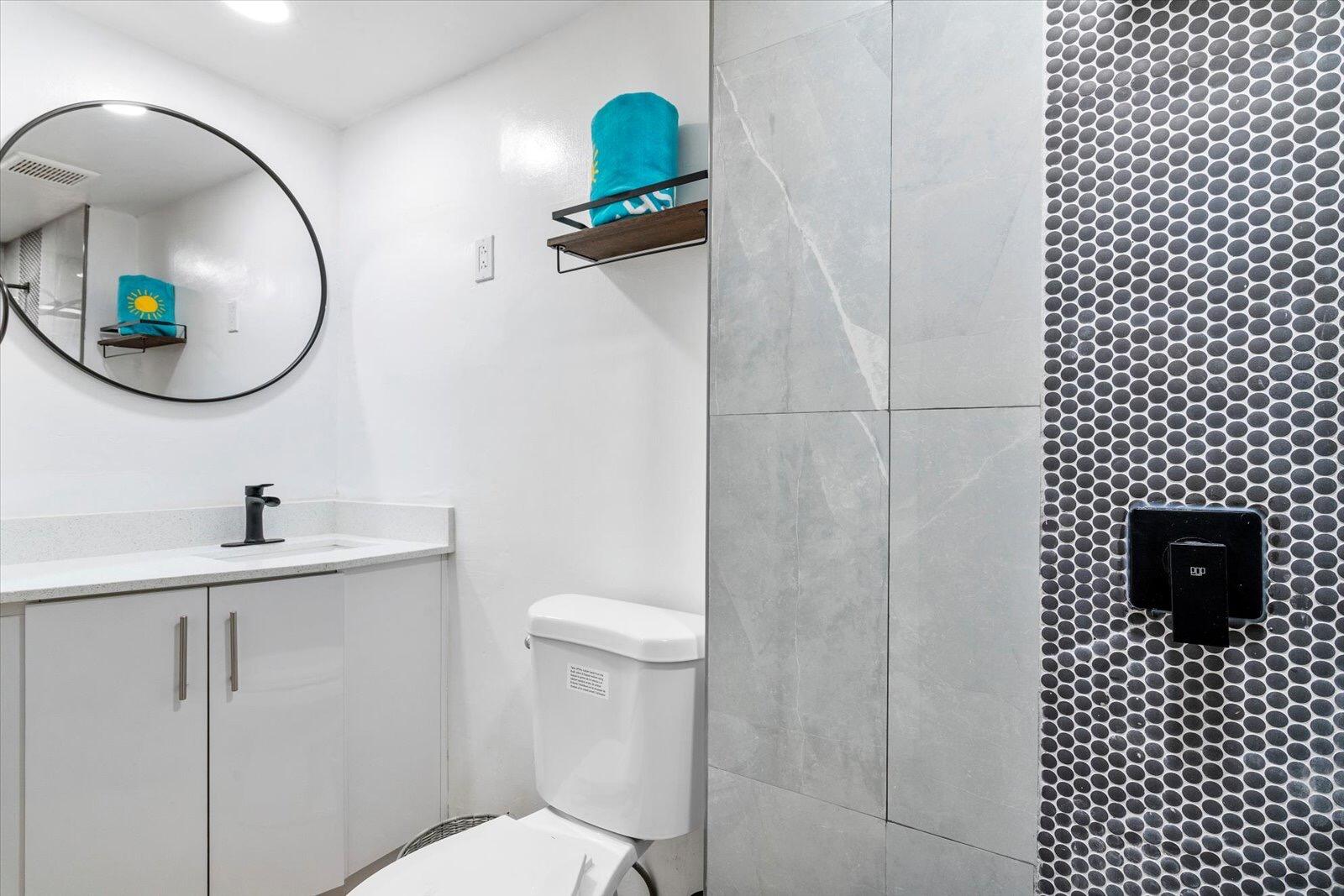 236 Southwest 14th Street Dania Beach, FL 33004 - Photo 16 of 19 a bathroom with a sink a toilet and a mirror