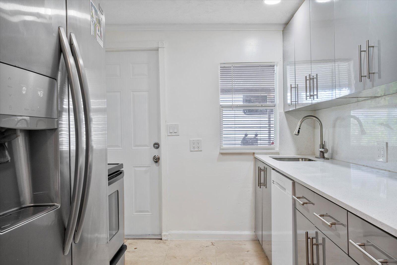 236 Southwest 14th Street Dania Beach, FL 33004 - Photo 6 of 19 a kitchen with stainless steel appliances a sink and a refrigerator
