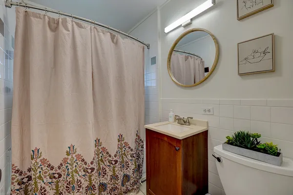 a bathroom with a toilet a sink and a mirror