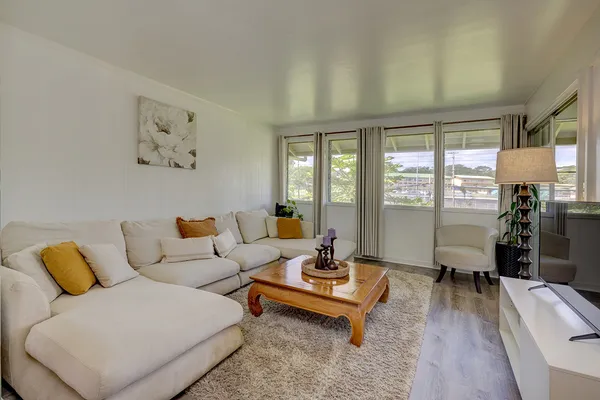 a living room with furniture and wooden floor