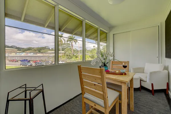 a dining room with furniture and window