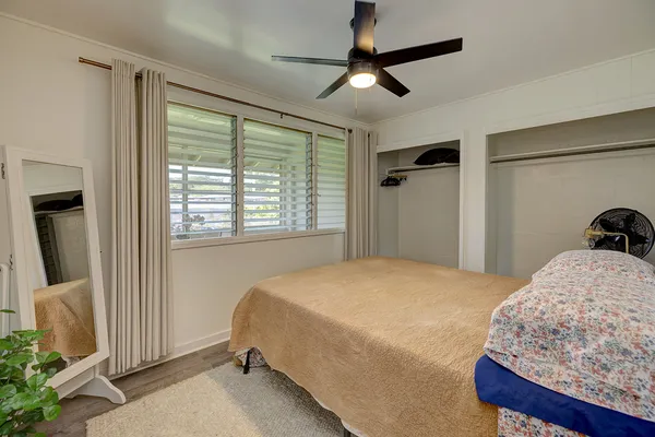 a bedroom with a large bed and a window