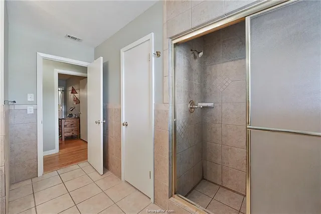 a bathroom with a shower and a sink