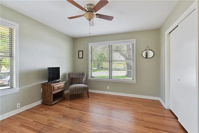 a view of a livingroom with workspace and a window
