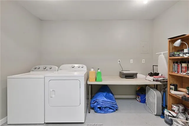 a view of storage and utility room with washer and dryer