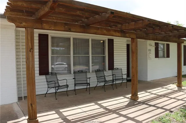 a balcony with table and chairs