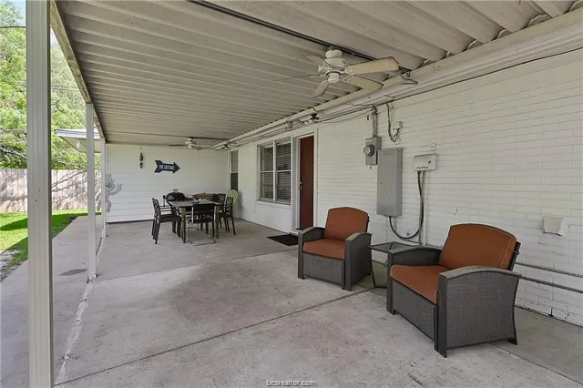 a view of an outdoor dining space with a table and chairs