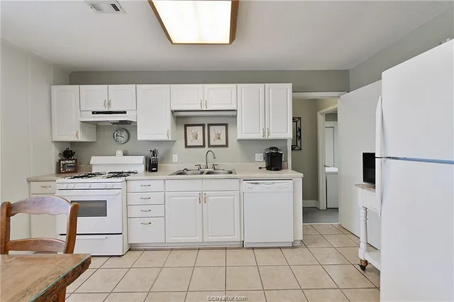 a kitchen with appliances cabinets and a sink