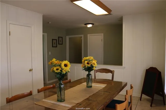 a dining room filled with furniture and flowers