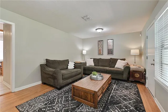 a living room with furniture and a rug