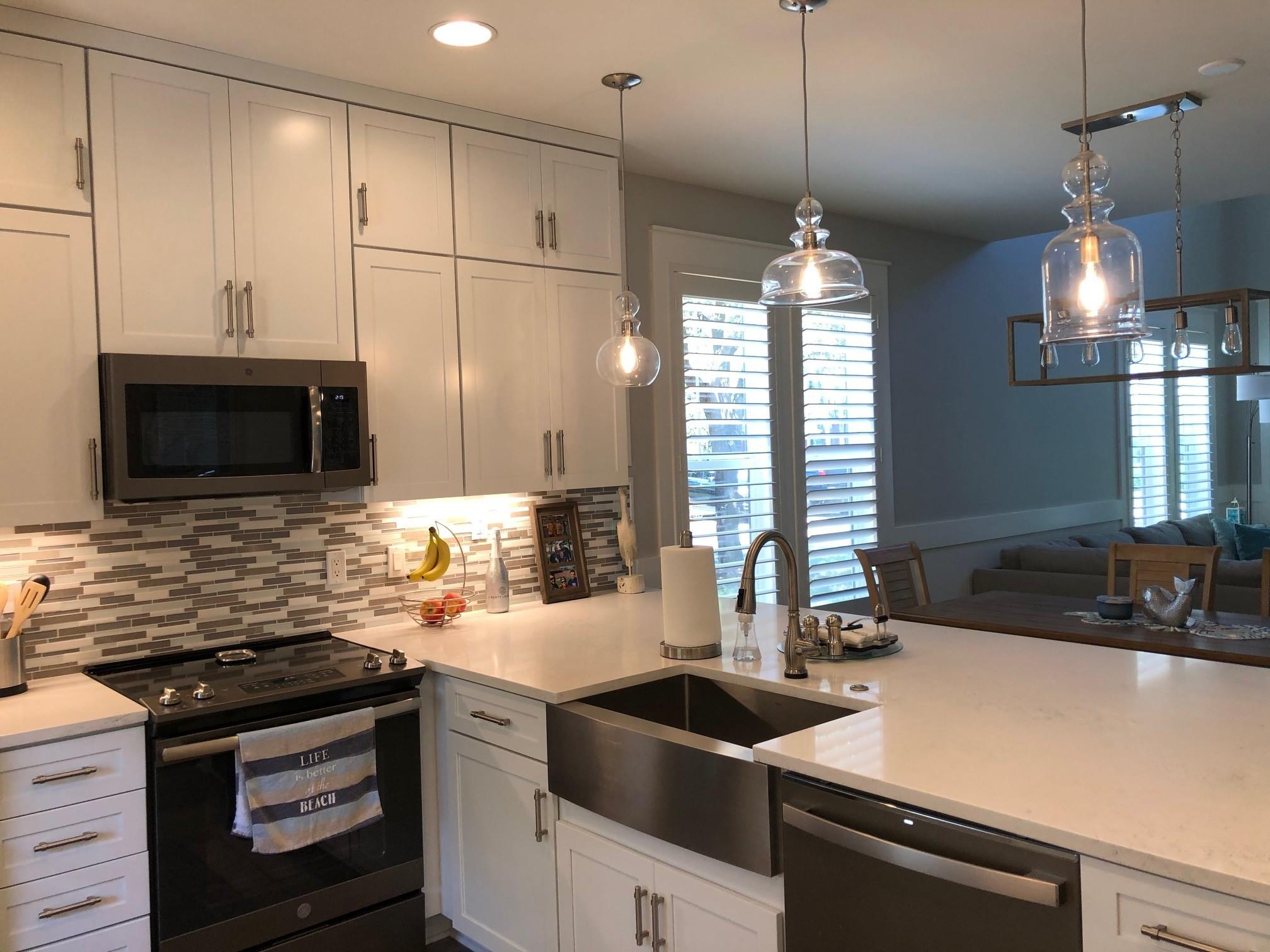 1384 Ravens Run West Miramar Beach, FL 32550 - Photo 12 of 21 a kitchen with stainless steel appliances granite countertop a sink a stove and a microwave