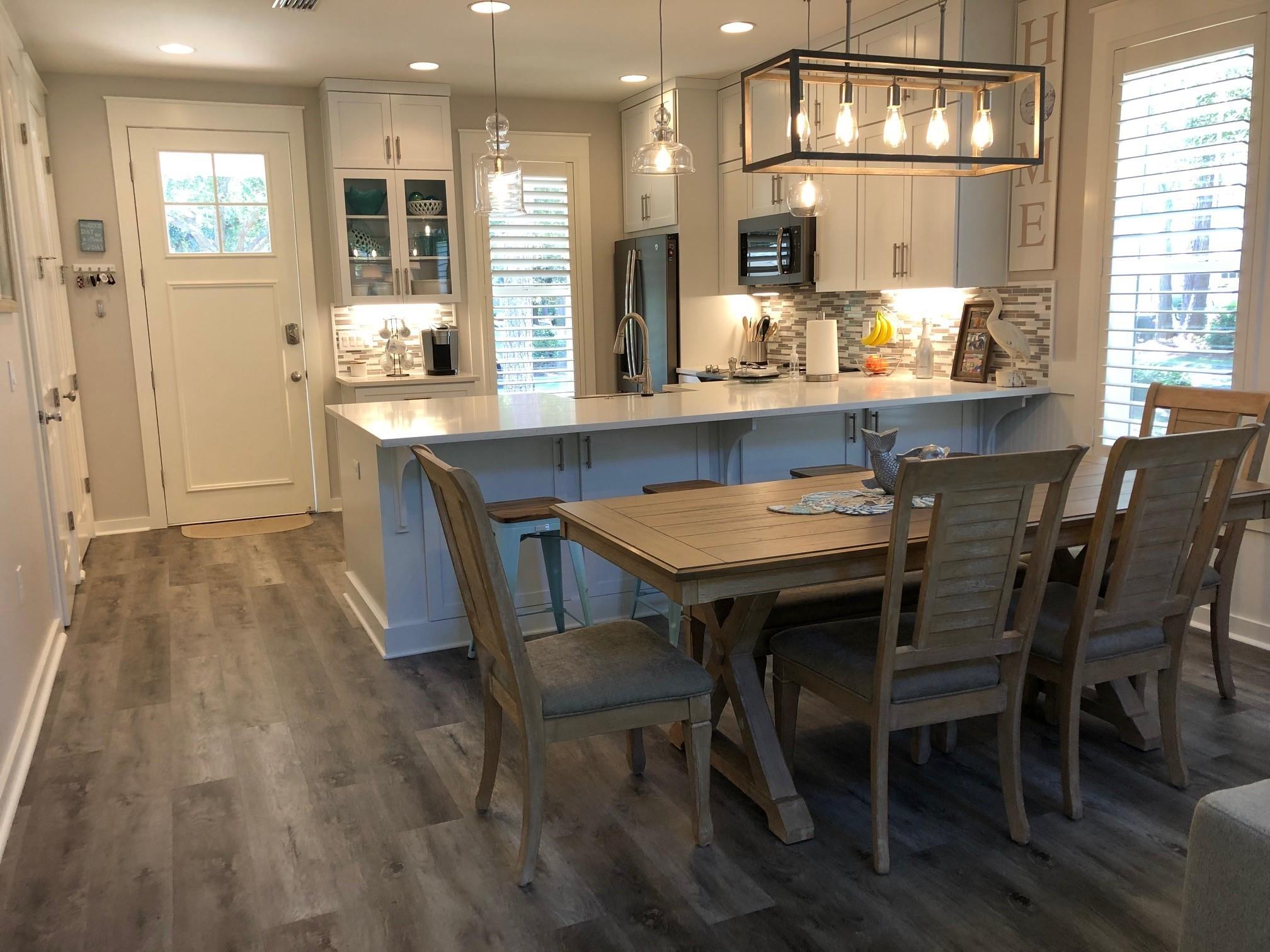 1384 Ravens Run West Miramar Beach, FL 32550 - Photo 13 of 21 a dining room with stainless steel appliances a table and chairs