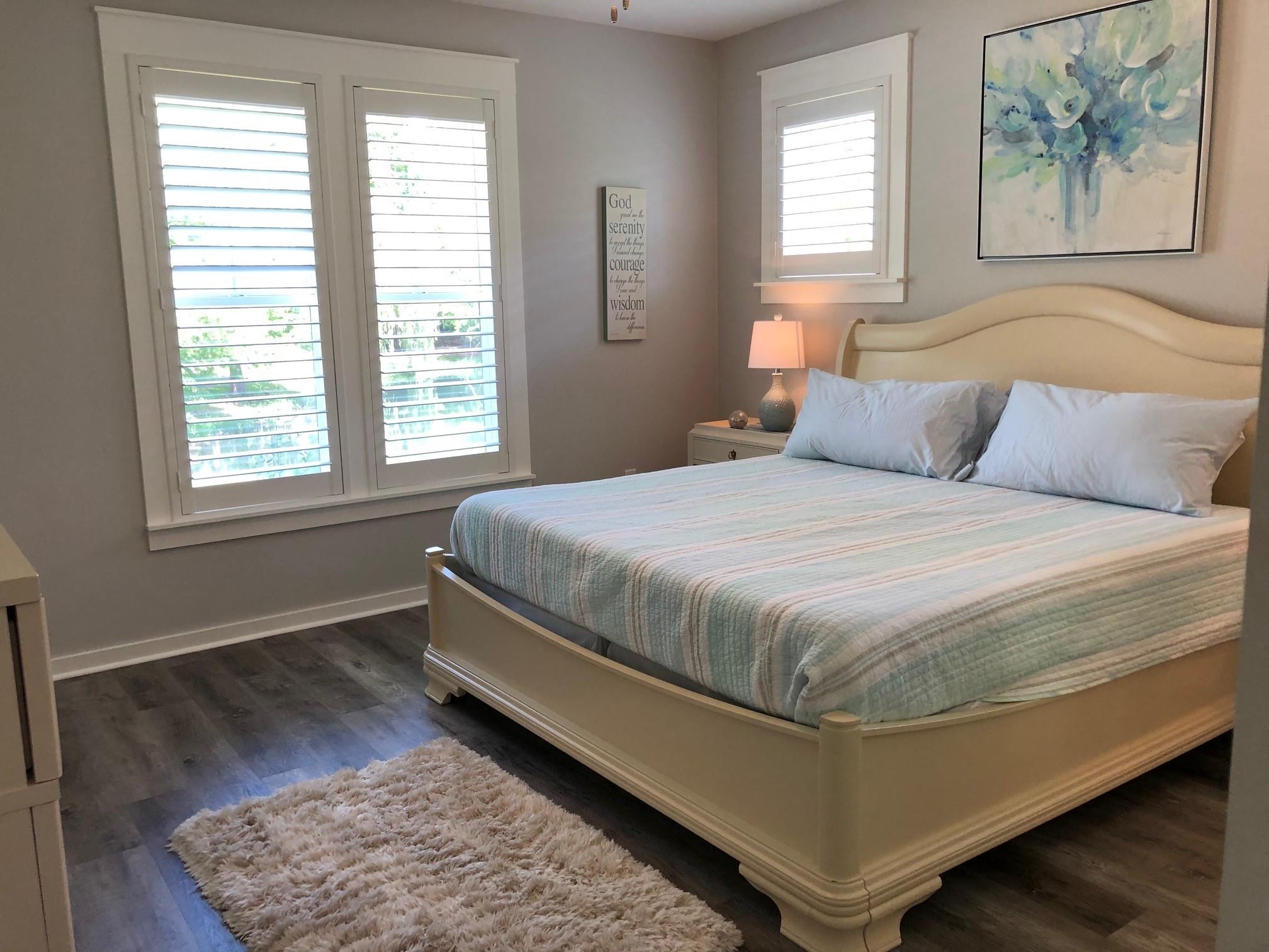 1384 Ravens Run West Miramar Beach, FL 32550 - Photo 16 of 21 a bedroom with a bed and wooden floor