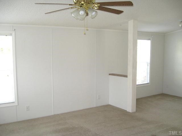4180 Oxford Road Roxboro, NC 27574 - Photo 6 of 12 Master suite with ceiling fan, sitting area, & huge walk-in closet
