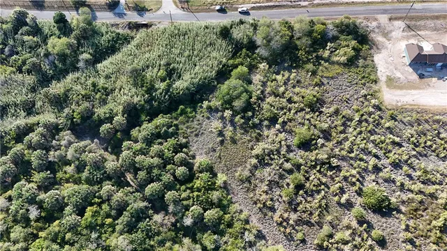 an aerial view of a houses with a yard