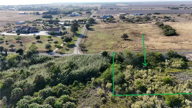 an aerial view of a houses with a yard