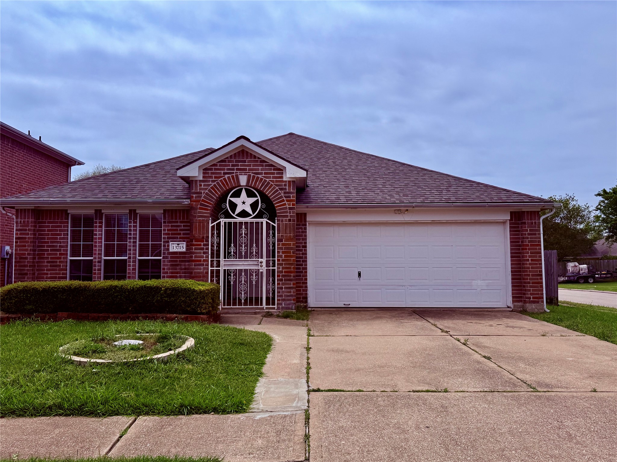 13715 Audra Lane Houston, TX 77083 - Photo 1 of 25 a front view of a house with a garden
