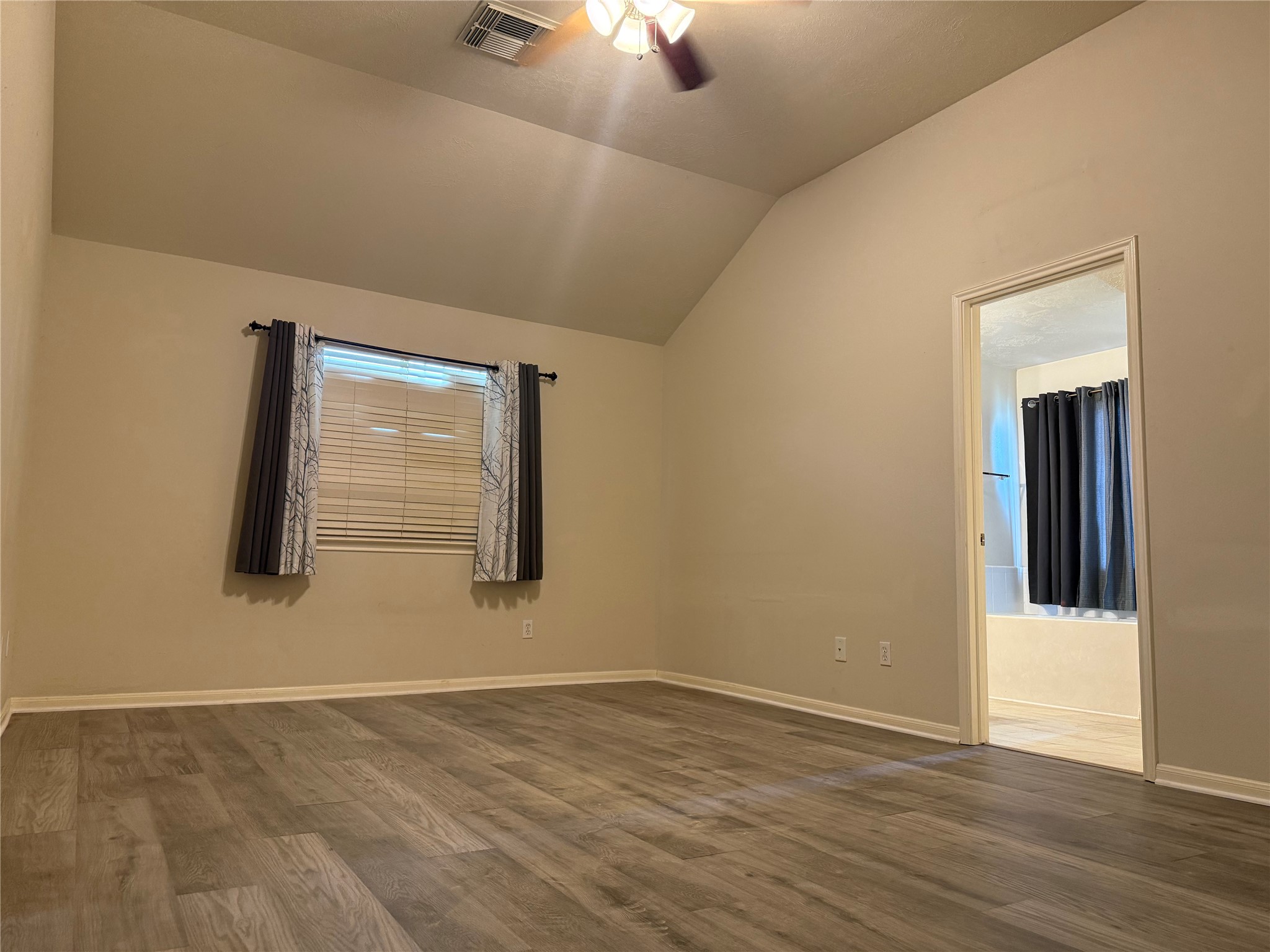 13715 Audra Lane Houston, TX 77083 - Photo 12 of 25 a view of an empty room with wooden floor and a window