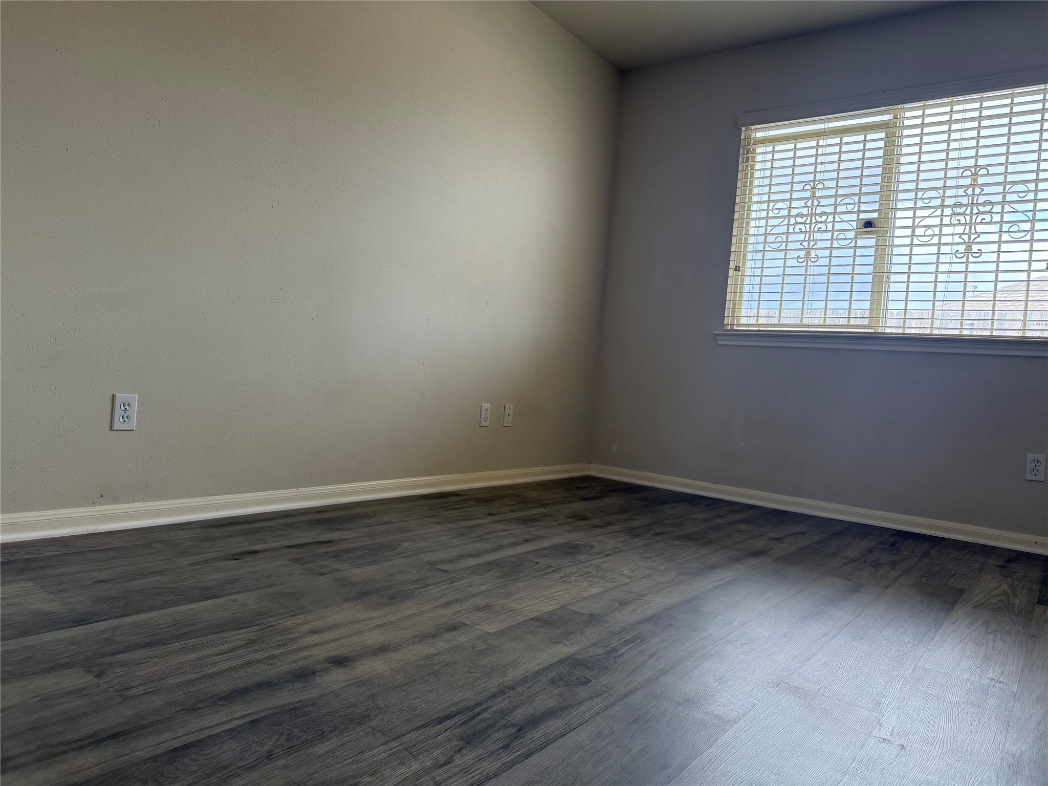 13715 Audra Lane Houston, TX 77083 - Photo 18 of 25 a view of an empty room with wooden floor and a window