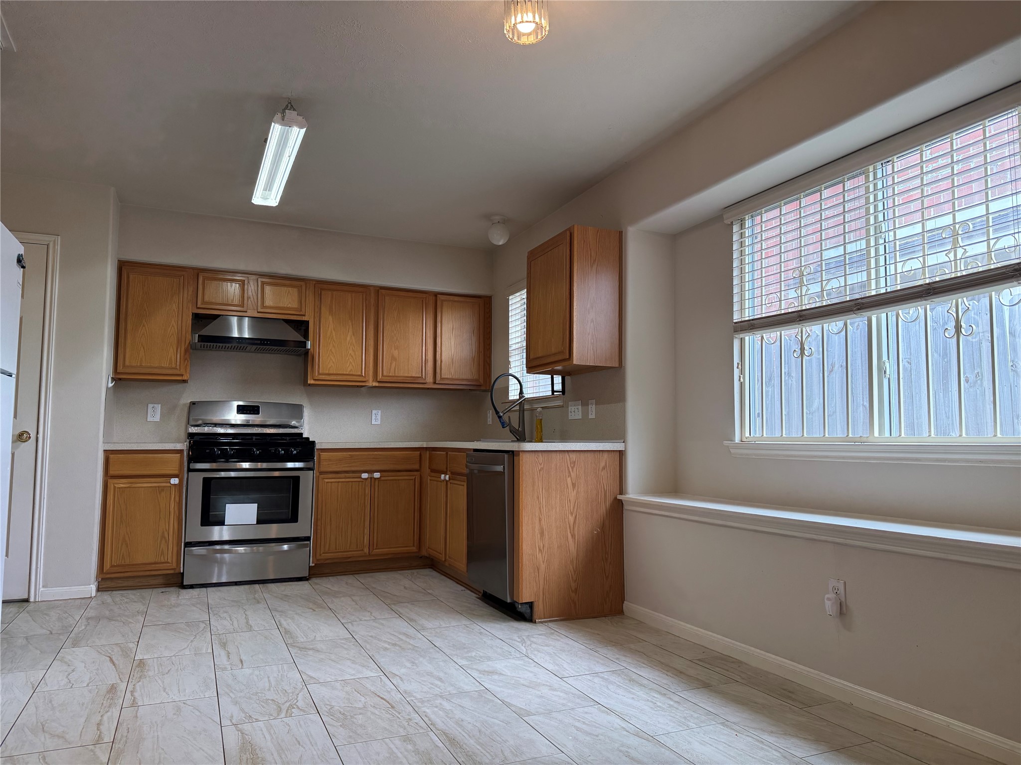 13715 Audra Lane Houston, TX 77083 - Photo 4 of 25 a kitchen with stainless steel appliances granite countertop a stove a sink and a refrigerator