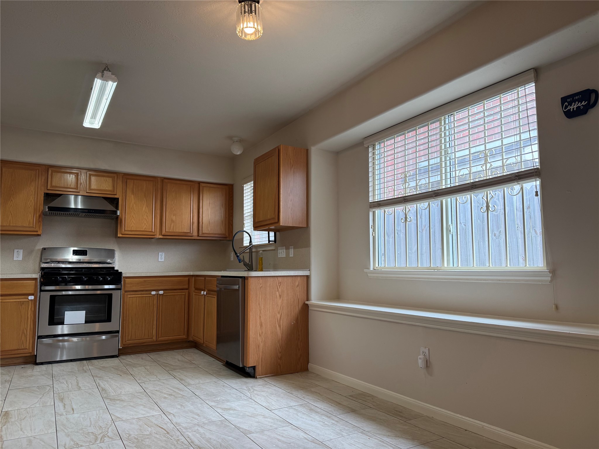 13715 Audra Lane Houston, TX 77083 - Photo 5 of 25 a kitchen with stainless steel appliances granite countertop a stove and a sink