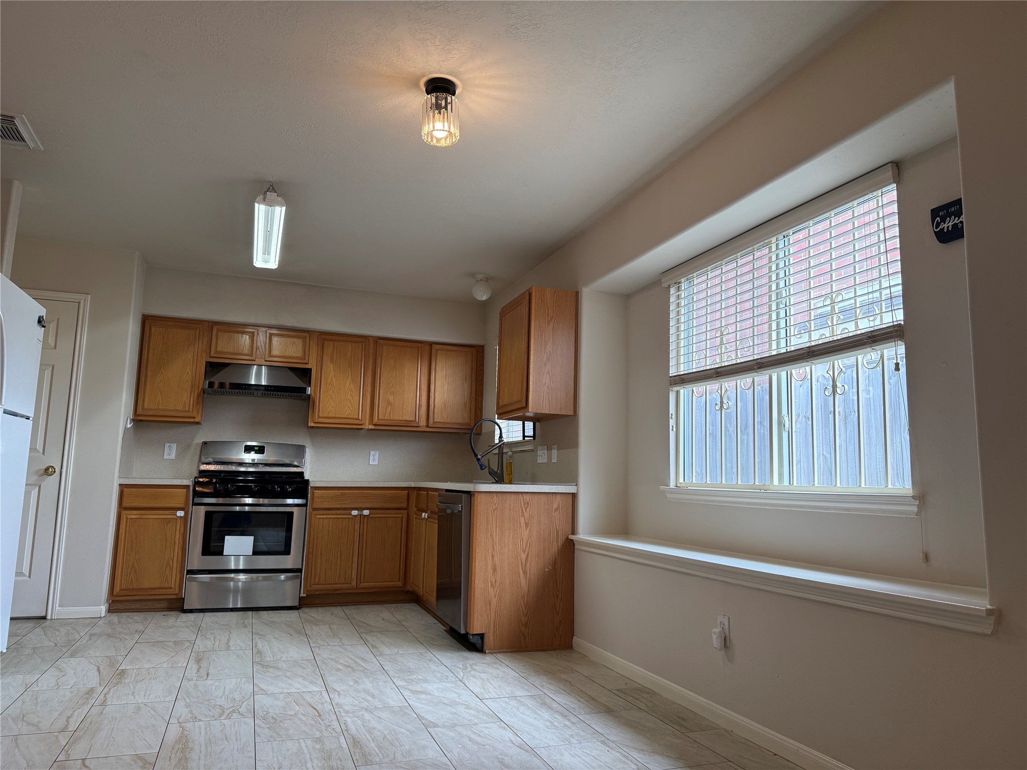 13715 Audra Lane Houston, TX 77083 - Photo 8 of 25 a kitchen with stainless steel appliances granite countertop a stove and a refrigerator
