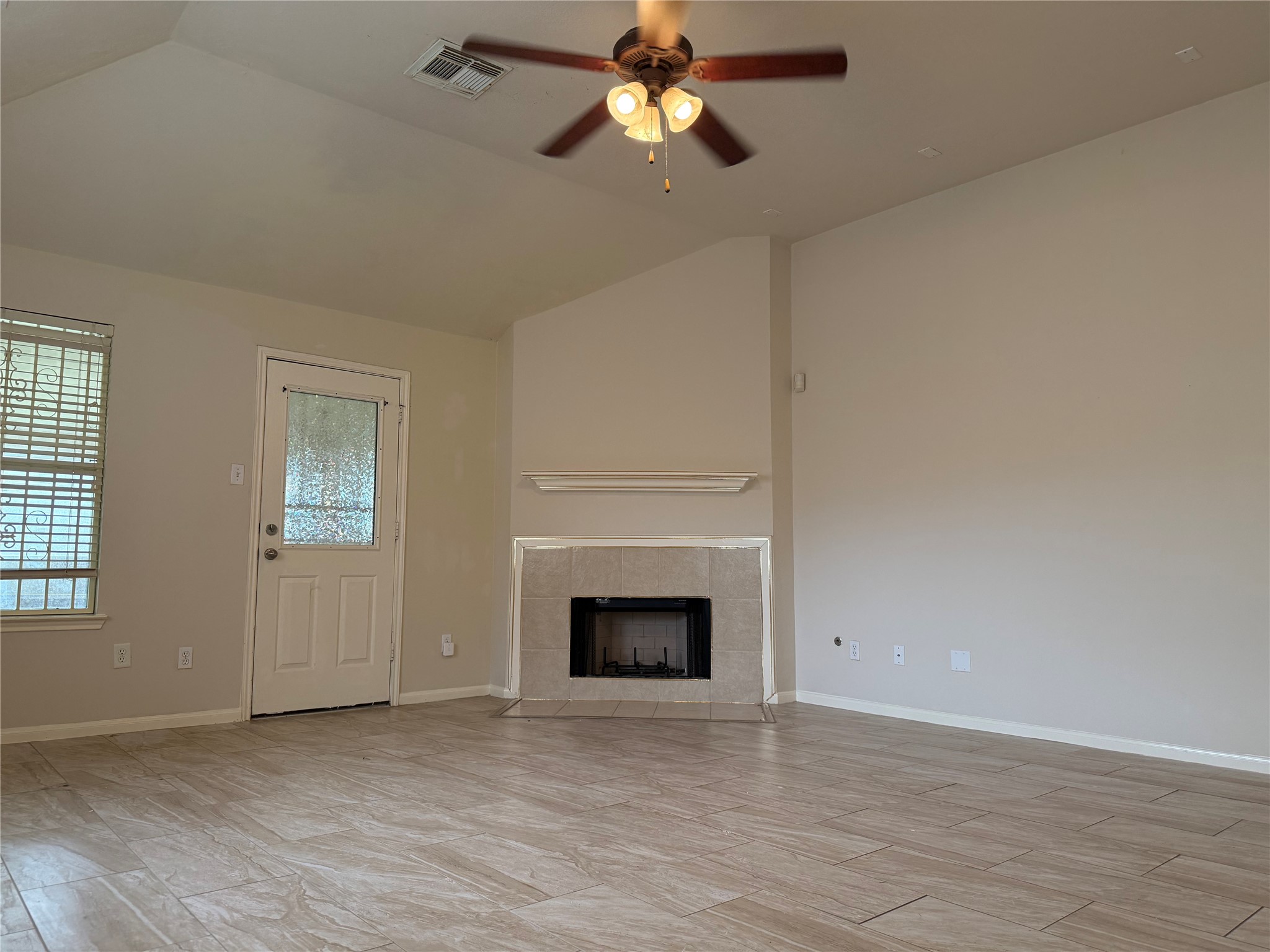 13715 Audra Lane Houston, TX 77083 - Photo 9 of 25 a view of empty room with fireplace and fan