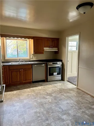 a view of a kitchen with a sink cabinets and a fireplace