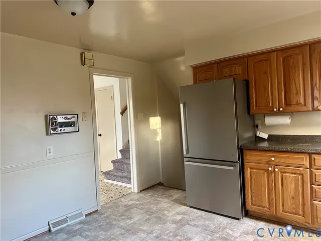 a kitchen with stainless steel appliances granite countertop a refrigerator and a sink