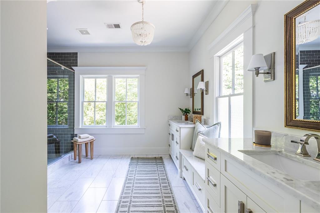 538 Ansley Street Decatur, GA 30030 - Photo 35 of 73 a spacious bathroom with a double vanity sink a mirror and a bathtub