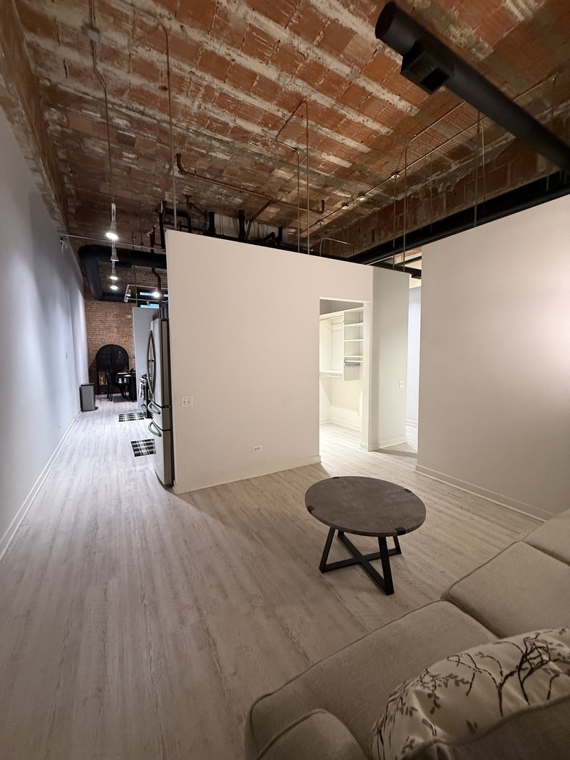 222 South Racine Avenue, Unit 207 Chicago, IL 60607 - Photo 11 of 29 a living room with a couch and a table