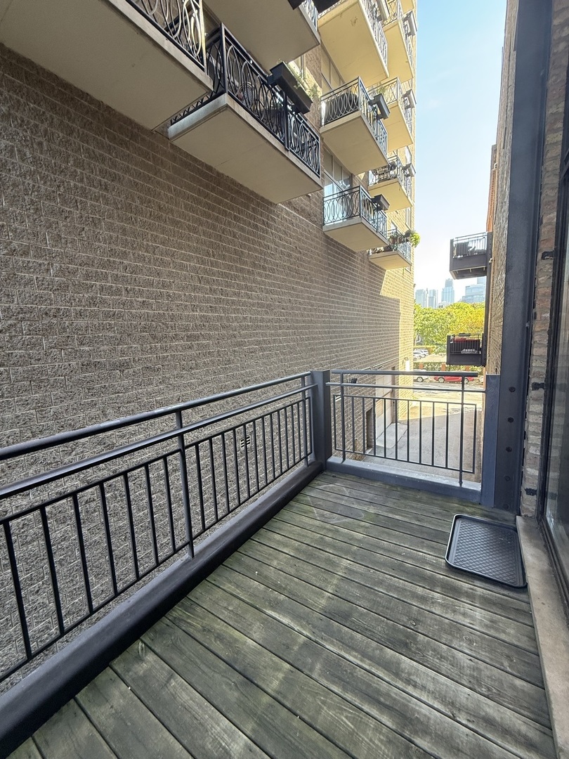 222 South Racine Avenue, Unit 207 Chicago, IL 60607 - Photo 27 of 29 a view of a balcony with wooden floor