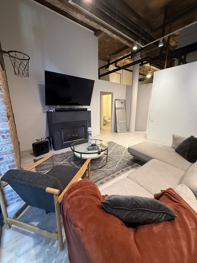 222 South Racine Avenue, Unit 207 Chicago, IL 60607 - Photo 3 of 29 a bedroom with a bed and a flat screen tv