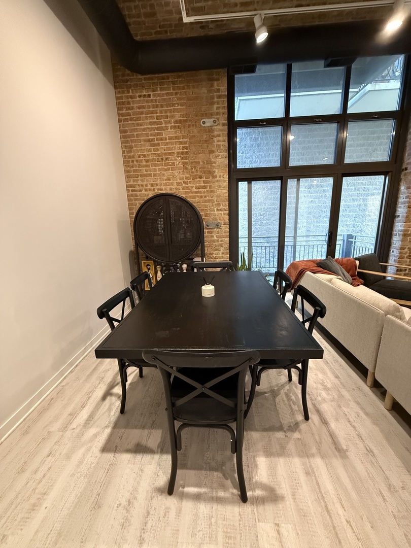 222 South Racine Avenue, Unit 207 Chicago, IL 60607 - Photo 4 of 29 a view of a dining room with furniture window and outside view