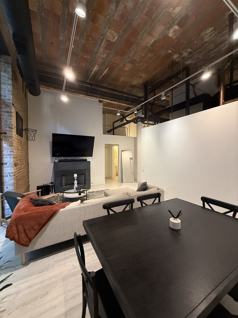 222 South Racine Avenue, Unit 207 Chicago, IL 60607 - Photo 7 of 29 a bed sitting in a room next to a window