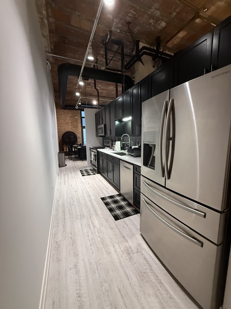 222 South Racine Avenue, Unit 207 Chicago, IL 60607 - Photo 9 of 29 a kitchen with stainless steel appliances a refrigerator and a stove