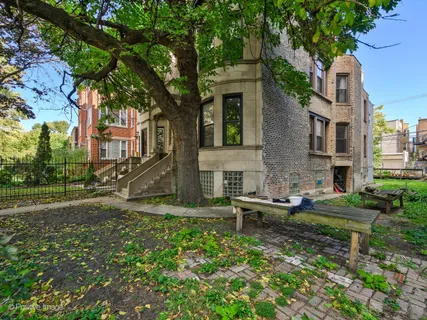 a view of a house with backyard and sitting area