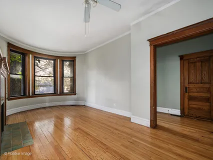 a view of wooden floor and windows in a room