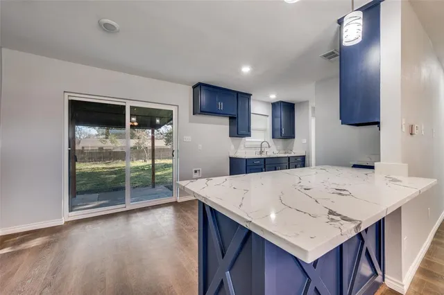a kitchen with wooden cabinets and stainless steel appliances