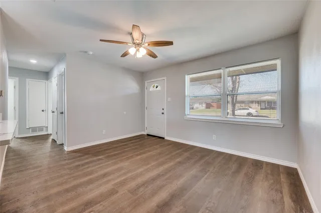 wooden floor in an empty room with a window